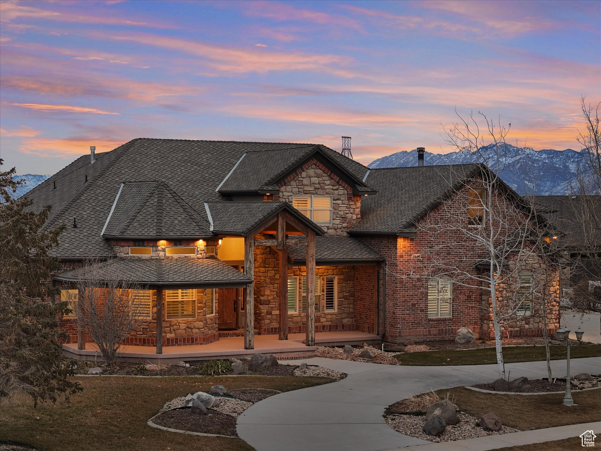 Sitting on a full acre lot with sweeping views from the Wasatch to the Oquirrh Mountains, this exceptional Bluffdale horse property offers a tranquil country atmosphere while remaining close to all conveniences. The striking exterior of this home, with its blend of brick, stone, and timber, makes an immediate impression. Inside, the spacious layout features 7 bedrooms, 6 bathrooms, an office, a library, a craft room, a theater room, and a versatile multipurpose room. Don't miss the hidden playroom connecting the closets of the upstairs bedrooms! The kitchen, fully remodeled in 2020, boasts high-end cabinets, countertops, and appliances and flows directly into the dining room and large great room. Step onto the 1,000 sq ft deck and enjoy breathtaking valley and mountain views. The expansive 1,200 sq ft main garage includes epoxy floors, ample room for an RV or trailer, and abundant additional storage space. The fully finished basement features a private 4-bed, 2-bath residence, insulated and soundproofed from the main house. It has its own entrance from the back patio and attached one-car garage, offering the perfect setup for multi-generational living,  long, or short-term rental.  The beautifully landscaped yard includes a fire pit, hammock poles, and more! In the back corner of the lot, is a 12x16 fully finished, insulated shed/office with French doors, large windows, and its own HVAC system. A garden area with a separate sprinkler system, an additional 18x25 metal garage and plenty of parking space for toys or work equipment complete the property. Utilities including water, electrical, sewer, and internet are already stubbed at the back, ready for your dreams - whether a horse corral, workshop, garage, or extra living space.