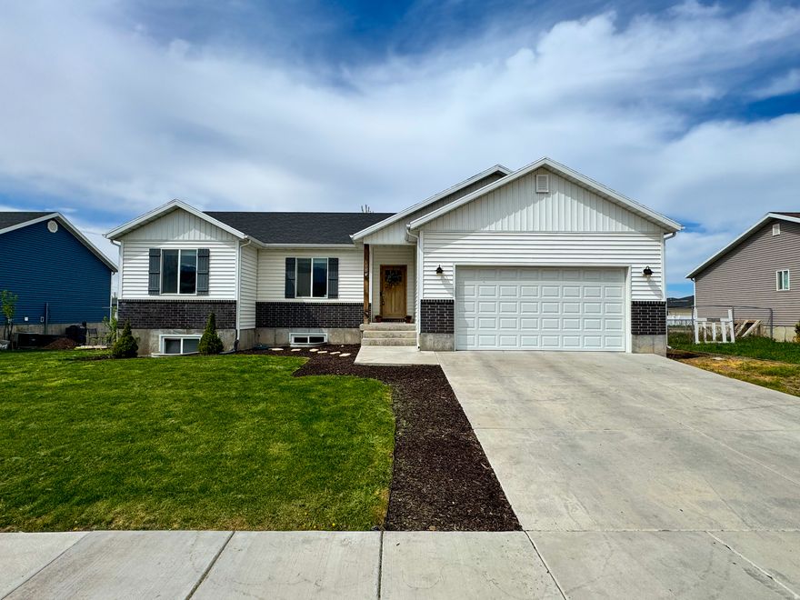 ***BROKER/AGENT OPEN HOUSE FRI 4/17/2026 5:00 PM-7:00 PM. No Showings Until After GRAND OPEN HOUSE SAT 4/18/2026 11:00 AM-2:00 PM*** HONEY, STOP THE CAR! This beautiful 2018 rambler in a quiet Tremonton neighborhood offers 3 bedrooms, 2 bathrooms, and an open-concept layout with vaulted ceilings and tons of natural light. The kitchen features ample cabinetry, quality finishes, and a spacious pantry, flowing seamlessly into the main living areas. The primary suite includes a walk-in closet and Master bathroom (with two additional bedrooms perfect for guests, home office, etc. The unfinished basement also soaks in a ton of natural light with it's large windows. The basement also offers ample potential to grow- if this were to be finished out then you could literally double the livable space of the home! Step outside to a fully fenced backyard where you can create your own oasis to relax or entertain. This gem is perfectly situated not far from schools, parks, and amenities highlighted with a beautiful mountain backdrop and beautiful views in every angle. This one is move-in ready and ready for you!!!
