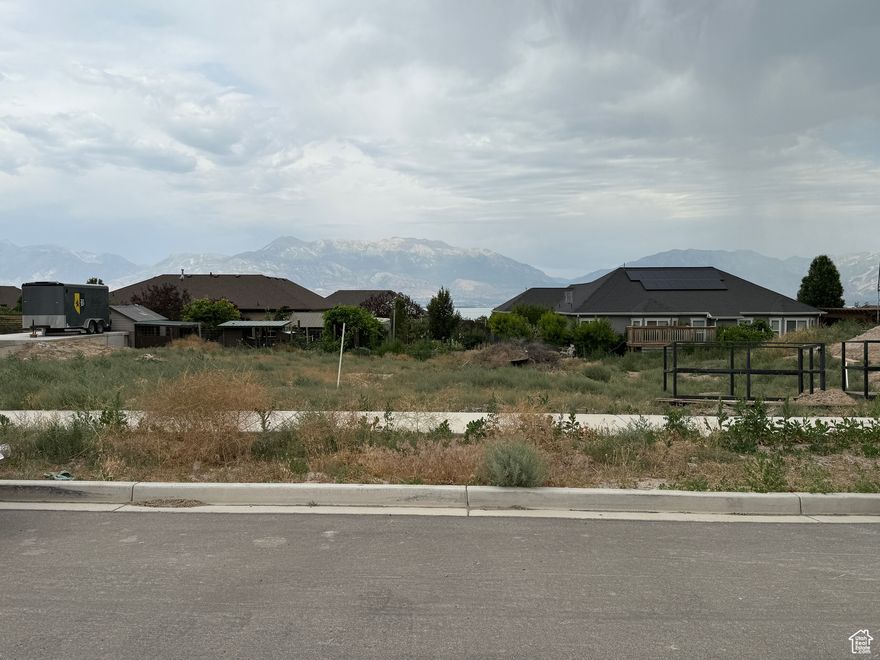 Located in the highly sought-after Jacobs Ranch subdivision, this spacious 0.27-acre lot offers stunning views of the mountains, valley, and Utah Lake. With all utilities stubbed and no HOA restrictions, it's the perfect site to create a custom home in a peaceful, established neighborhood. Just minutes from schools, parks, shopping, and hiking trails-opportunities like this are rare!
