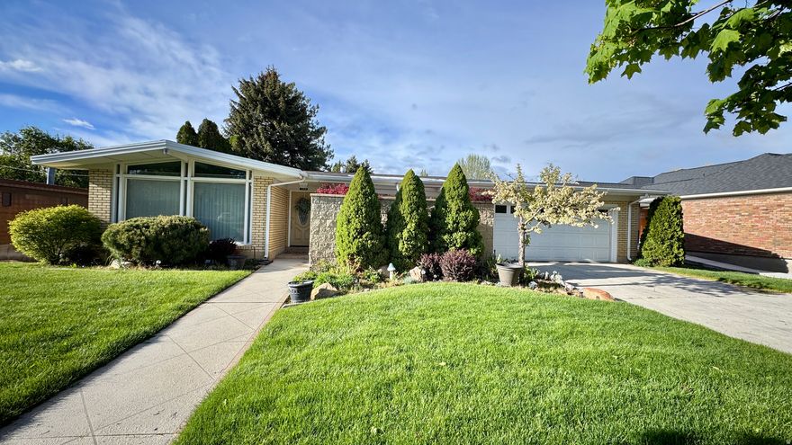 This home has been designed for comfort and flexibility, the home features two separate living areas, two full gourmet kitchens, two impressive fireplaces, and two laundry rooms. You'll love the custom lighting throughout and the rich hardwood floors that add warmth and elegance. Major systems are already in place with two furnaces, two water heaters, and central A/C, providing efficiency and peace of mind. Step outside to enjoy a covered deck, private front patio, and a spacious backyard patio, perfect for entertaining or relaxing. The large backyard offers endless possibilities, and the unique outbuilding adds even more versatility. Don't miss the oversized basement fruit room for additional storage. Opportunities like this don't come around often...schedule your showing today!