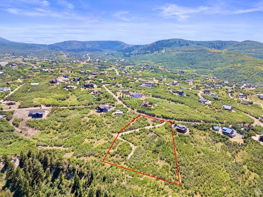 Wake up to crisp mountain air, panoramic views, and the serenity of nature surrounding you. If you've been searching for the perfect canvas to create your legacy mountain home or peaceful retreat, this gently sloped 2.41 acre uphill lot could be the one. Nestled in the scenic Timberlakes community, it offers breathtaking views of Mount Timpanogos, the top of Snowbird, and Heber Valley.  This property offers over double the space of many nearby lots, making it more scenic, more private, and more coveted. With greater distance between homesites, you'll enjoy added tranquility, fewer neighbors, and a more expansive connection to the land around you, all while being part of a secure, established mountain community.  This lot is fully prepared and ready to build, saving you valuable time and money. Key improvements already completed include approved septic plans, a grading and drainage plan, structural and hydraulic calculations, slope map analysis, a completed geotechnical study, and an approved site plan. Even more valuable, the lot includes engineered and approved architectural plans for a beautifully designed 4 bedroom custom mountain home. The design features a walk-out basement, 12 foot ceilings in the main-level living room, 10 foot ceilings throughout the rest of the home, and is expertly positioned to capture the stunning views shown in the photos. Water, power, and high-speed internet are available at the road, allowing you to begin building immediately.  Located within Timberlakes, a private, gated community with year round road access, this lot is ideally situated just around the corner from Clyde Lake, scenic hiking trails, and direct access to world-class snowmobiling in the High Uinta Mountains. Whether you're envisioning a tranquil second home or a full-time mountain lifestyle, this property offers the perfect blend of natural beauty, outdoor adventure, and build ready convenience.  Adventure and serenity meet here, come build something unforgettable.  Acreage figures & property outline were obtained from county records. Buyer is advised to obtain an independent measurements and outline. Buyer and Buyer's Agent to verify all information, which has been provided as a courtesy only. All information is deemed reliable but not guaranteed.