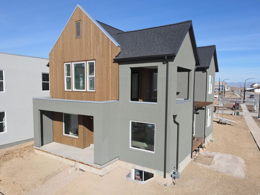 Brand New Home with the striking new cedar wood exterior option! Enjoy stunning views from the many outdoor areas in this popular Adventurer floor plan! Price includes impressive designer upgrades such as: 9-foot ceilings on all levels, A cozy fireplace, modern railing, coveted indoor/outdoor living layout with oversized sliding glass doors connecting the Great Room and Kitchen with outdoor patio space. The main-level office is filled with natural light thanks to abundant windows perfect for work or relaxation. Upstairs, the dreamy Primary Suite features its own covered, hot tub-ready balcony, along with a luxurious en-suite bathroom complete with a stand-alone soaking tub and a spacious walk-in shower. Full landscaping and a fenced side/backyard. Estimated completion: Feb-March 2026.