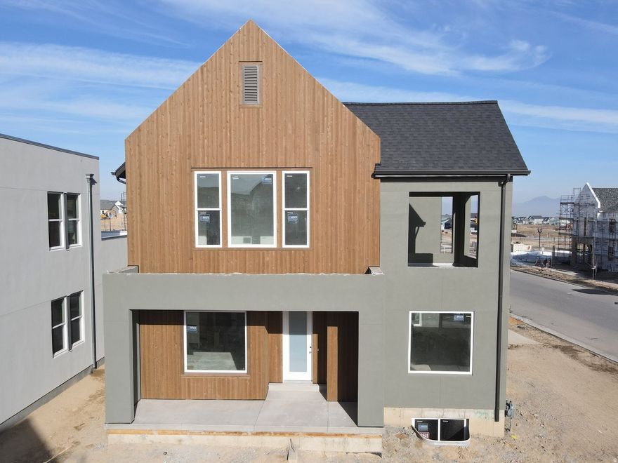 Brand New Home with the striking new cedar wood exterior option! Enjoy stunning views from the many outdoor areas in this popular Adventurer floor plan! Price includes impressive designer upgrades such as: 9-foot ceilings on all levels, A cozy fireplace, modern railing, coveted indoor/outdoor living layout with oversized sliding glass doors connecting the Great Room and Kitchen with outdoor patio space. The main-level office is filled with natural light thanks to abundant windows perfect for work or relaxation. Upstairs, the dreamy Primary Suite features its own covered, hot tub-ready balcony, along with a luxurious en-suite bathroom complete with a stand-alone soaking tub and a spacious walk-in shower. Full landscaping and a fenced side/backyard. Estimated completion: Feb-March 2026.