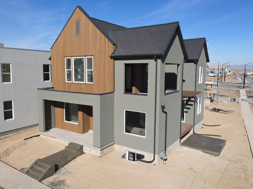 Brand New Home with the striking new cedar wood exterior option! Enjoy stunning views from the many outdoor areas in this popular Adventurer floor plan! Price includes impressive designer upgrades such as: 9-foot ceilings on all levels, A cozy fireplace, modern railing, coveted indoor/outdoor living layout with oversized sliding glass doors connecting the Great Room and Kitchen with outdoor patio space. The main-level office is filled with natural light thanks to abundant windows perfect for work or relaxation. Upstairs, the dreamy Primary Suite features its own covered, hot tub-ready balcony, along with a luxurious en-suite bathroom complete with a stand-alone soaking tub and a spacious walk-in shower. Full landscaping and a fenced side/backyard. Estimated completion: Feb-March 2026.