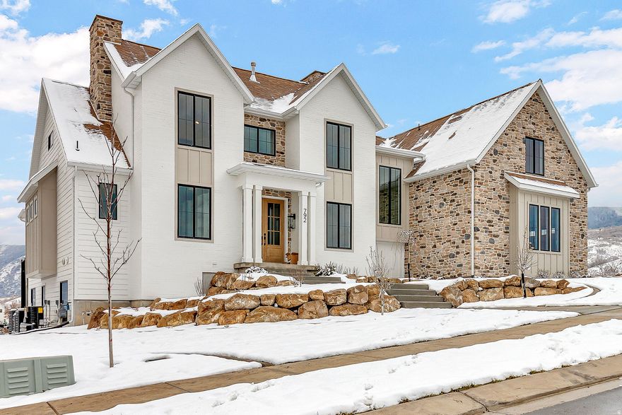 **Home to be complete in time for the holidays! Ask about our preferred lender rate buy down!**This custom home features six bedrooms, six bathrooms, a three-car garage, a large covered deck, and views of Mount Loafer. The property backs to a wooded grove with no neighbors behind, making it perfect for wildlife viewing from the deck or patio. You can also enjoy the scenery while working out in the indoor/outdoor gym. The exterior combines gable rooflines, board-and-batten siding, and black-framed windows, offering a blend of rustic charm and modern style. Architectural details like the covered entry and varied textures add visual interest and warmth, creating an inviting and functional appearance. The home includes a private gym and theater, with tile and trim work throughout that enhance the comfort and elegance of the space, ideal for relaxing and entertaining.