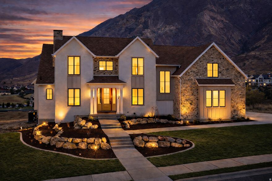 This custom home features 6 bedrooms, 6 bathrooms, a 3 car garage, a large covered deck, and views of Mount Loafer. This property is perfect for wildlife viewing from the deck or patio. You can also enjoy the scenery while working out in the indoor/outdoor gym. The exterior combines gable rooflines, board-and-batten siding, and black framed windows, offering a blend of rustic charm and modern style. Architectural details like the covered entry and varied textures add visual interest and warmth, creating an inviting and functional appearance. The home includes a gym, open theater, a massive garage, tons of storage and so much more!