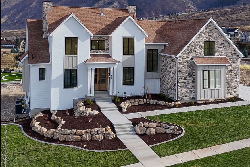 **LIMITED TIME OFFER: Up to $36,000 toward a 2-1 rate buy down when you use our preferred lender PLUS enjoy a $10,000 builder credit!** This custom home features 6 bedrooms, 6 bathrooms, a 3 car garage, a large covered deck, and views of Mount Loafer. This property is perfect for wildlife viewing from the deck or patio. You can also enjoy the scenery while working out in the indoor/outdoor gym. The exterior combines gable rooflines, board-and-batten siding, and black framed windows, offering a blend of rustic charm and modern style. Architectural details like the covered entry and varied textures add visual interest and warmth, creating an inviting and functional appearance. The home includes a gym, open theater, a massive garage, tons of storage and so much more!