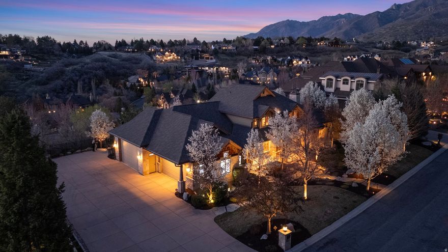 Located within the highly coveted 477 acre, 24-hour guard-gated Pepperwood community, this remarkable luxury residence offers an exceptional opportunity to own a private retreat in one of Salt Lake Valley's most prestigious enclaves. Surrounded by mature landscaping and set against the dramatic backdrop of the Wasatch Mountains, the property seamlessly blends timeless elegance with refined modern comfort. From the moment you enter, the home makes a striking impression with its grand entry and expansive windows that frame breathtaking mountain and valley views while flooding the interior with natural light. Thoughtfully designed for both intimate living and large-scale entertaining, the residence features multiple gracious living and gathering spaces, each finished with exceptional attention to detail and quality craftsmanship throughout. The gourmet kitchen serves as the heart of the home, appointed with premium appliances, custom cabinetry, and generous counter space ideal for both everyday use and hosting. Adjacent dining and living areas create effortless flow, while inviting fireplaces and architectural accents add warmth and sophistication. The primary suite is a true sanctuary, offering a serene escape with tranquil views that enhance the sense of privacy and relaxation. Additional bedrooms and guest accommodations are generously sized and thoughtfully positioned to provide comfort, flexibility, and privacy for family and guests alike. The lower level and auxiliary living spaces extend the home's versatility,  offering a full Mother in law apt w laundry hook ups & kitchen, a 3rd kitchen, huge indoor basketball court ,fitness studio, media room,large heated workshop, extra tall ceilings, full walkout separate entrance, pool bathroom & additional entertaining space. The heated driveway enhances the oversized extra deep & wide 4 car garage which has extra tall doors for rv and trucks. Outdoor living is equally impressive, with beautifully manicured grounds,pool,spa,waterfall & inviting patios that capture the surrounding natural beauty of mountain & valley views-perfect for hosting gatherings or enjoying peaceful moments year-round. Residents of Pepperwood enjoy exclusive access to private amenities including tennis, basketball, pickleball courts, sand volleyball, pool, large  splash pad, lifeguards, pepperwood swim team, huge playground, park, miles of scenic walking/ biking trails, food trucks & community events.Step outside Pepperwood and you are within minutes of world-class ski resorts, premier hiking/biking trails, fine dining, upscale shopping, & downtown Salt Lake City. This is a rare offering that delivers elevated luxury living, exceptional privacy, and an unparalleled lifestyle in one of Utah's most distinguished communities.Buyer to verify all information