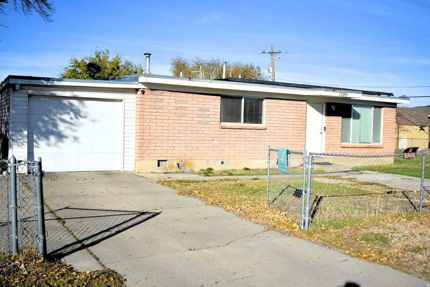 Charming brick rambler in a peaceful neighborhood! Nestled along a quiet stretch of 3300 S, this inviting main-floor living home maximizes every inch of space. Enjoy a private master half-bath, an RV pad, and additional front parking for convenience. The spacious, fully fenced corner lot provides plenty of room to relax or entertain, while the extra-deep garage offers ample storage. Energy-efficient solar panels help keep utility costs low. Perfectly located just minutes from freeway access, shopping, and dining-all within walking distance!