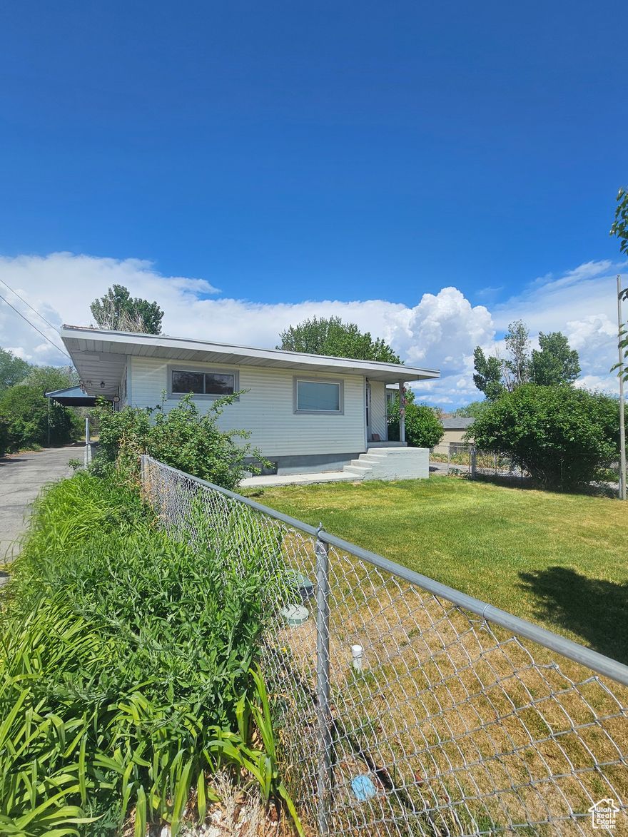 Country living just out of town.  fully fenced, room for horses. Features large garage workshop, fruit trees, garden spot and auto sprinkling system. Back yard asphalted with 2 driveways. 4 beds 3 baths updated home. newer kitchen and new windows. full basement could be rented for extra income.  Square footage figures are provided as a courtesy estimate only and were obtained from courthouse records .  Buyer is advised to obtain an independent measurement.