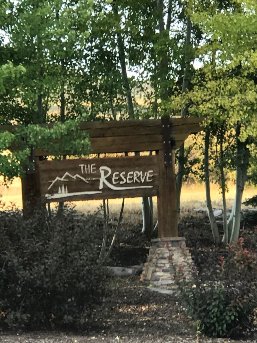 Build your DREAM HOME on this south facing lot located in the prestigious gated community of THE RESERVE AT BEAR LAKE  .  Engineered house plans are included in the price.  This homesite captures sweeping lake and mountain views while offering year round recreation outside your door.  Enjoy "Resort Style" amenities with one of the most desirable private Beaches on Bear Lake, an elegant club house with two swimming pools, hot tub, splash pad, sports court, exercise room, paved roads, and more. Direct access to the forest for ATV/Snowmobile trails year round.