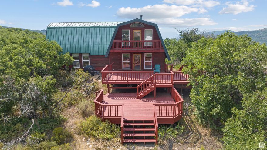 ***RECENT PRICE REDUCTION*** Tucked away in nature, this charming cabin is the ultimate retreat for anyone craving peace, privacy, and a true connection to the outdoors. Just steps from Clyde Lake, you can spend your summers paddle boarding or simply enjoying the tranquil scenery. The expansive, multi-level deck offers breathtaking mountain and wilderness views - perfect for quiet mornings with coffee, hosting summer BBQs, or stargazing under clear night skies. Inside, this well-built 2-bedroom cabin blends warm wood accents with an inviting open floor plan, filling every room with natural light and creating a seamless flow throughout the space. Timber Lakes is picturesque gated mountain community just minutes from downtown Heber, Midway, and Deer Creek Reservoir, you'll enjoy the perfect balance of seclusion and convenience.  Buyer to verify all.