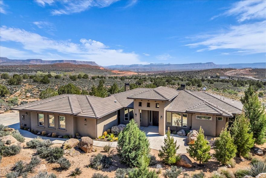 Just minutes from the historic Silver Reef mining district, where early prospectors once searched these desert hills for fortune, lies a 1.07-acre Leeds property offering something equally valuable today. The quiet satisfaction of a residence that feels truly earned. Surrounded by other one-acre homesites, the setting provides a peaceful rural lifestyle with sweeping views of the Red Cliffs National Conservation Area, Silver Reef, and Pine Valley Mountain. Single-level 2,498 sq. ft. features 4 bedrooms, 2.5 baths, formal living and dining rooms, a great room near the kitchen and casual dining area, plus a private office/den. Two fireplaces--located in the great room and primary suite--bring charm and aura. A front courtyard and covered back patio invite clean air, solitude, and relief. At 3,481' elevation, summers feel milder, and as a dark sky community, evenings reveal a breathtaking canopy of stars rarely seen in more developed areas.   Here, wide open space, desert views, and star-filled skies combine to create a place that feels both harmonious and enduring.