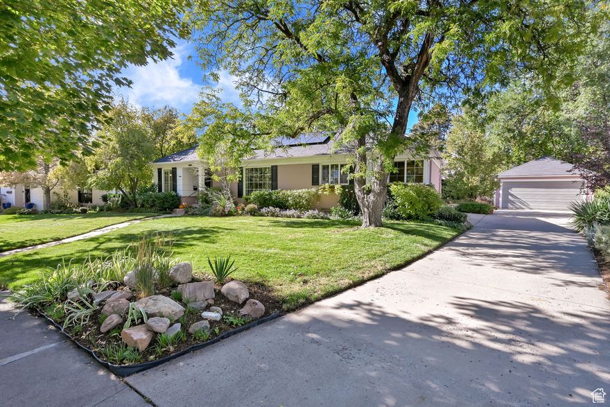 The location (Harvard/Yale area!) couldn't be better: walkable and rollable, with mature trees that line front yards and parking strips, meandering streets, metal lamp posts, and this particular location on Laird Drive has two circle greenbelts and views of the foothills. Easy main-level living rambler with a honey locust shade tree out front; a home that's clearly been cared for, and checks so many boxes. Large formal living room complete with wood floors, a fireplace, and a picture window that frames greenery, sky, neighbors tending gardens, and people strolling and/or rolling by. The kitchen has a cheerful corner window, updated appliances, fresh paint, and even space for a small dining table. Just off the kitchen, a mudroom leads outside. There's a large family room on the main floor with vaulted ceilings and another (gas) fireplace, a room that connects seamlessly to the living and bedroom areas, and French doors that open to the backyard; perfect as a cozy den, TV room, reading spot with built-in shelves, or could be converted into a primary suite. And there IS a main-floor primary suite! Along with a second bedroom, and another full bath. Downstairs space includes a second family room and bathroom, laundry area with new vinyl flooring, and loads of storage. The backyard is lush and shaded, with a gazebo ready for dining or entertaining. Chokecherry, crabapple, honeysuckle, lavender, iris. Add in the two-car garage and flat driveway with plenty of parking, and paid off solar panels that cover nearly 80% of the electric bill, plus a newer dual-fuel furnace and A/C. Approximately one mile to the University of Utah, 2.5 blocks to Laird Park, and a few blocks to either Foothill Village, or the ultra-charming embedded local restaurants and shops surrounding Harmons Emigration Market, Jolley's, Nomad East, and Emigration Cafe (with one of the best leafy patios in town). This is home!
