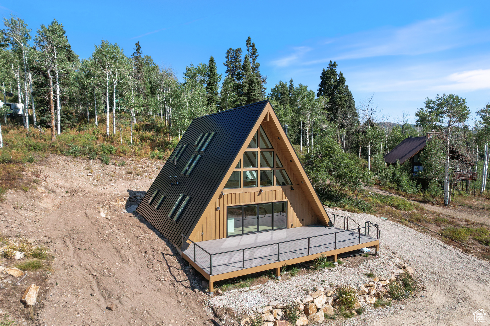 Welcome to your mountain modern A-frame retreat just 15 minutes from Park City. Completed in the summer of 2025, this brand-new 3-bedroom, 2-bath cabin spans 2,021 square feet and blends timeless architecture with high-end finishes and an Instagram-worthy interior. Soaring ceilings, abundant skylights, and walls of windows fill the open-concept great room with natural light, while a luxury kitchen with top-tier appliances and custom details elevates the living experience. Built-in bunk beds add charm and functionality, making the home perfect for family or guests. Step outside onto the expansive front deck to take in sweeping mountain views and frequent wildlife sightings. Approved for nightly rentals, this property offers both the ultimate personal getaway and an exceptional investment opportunity.
