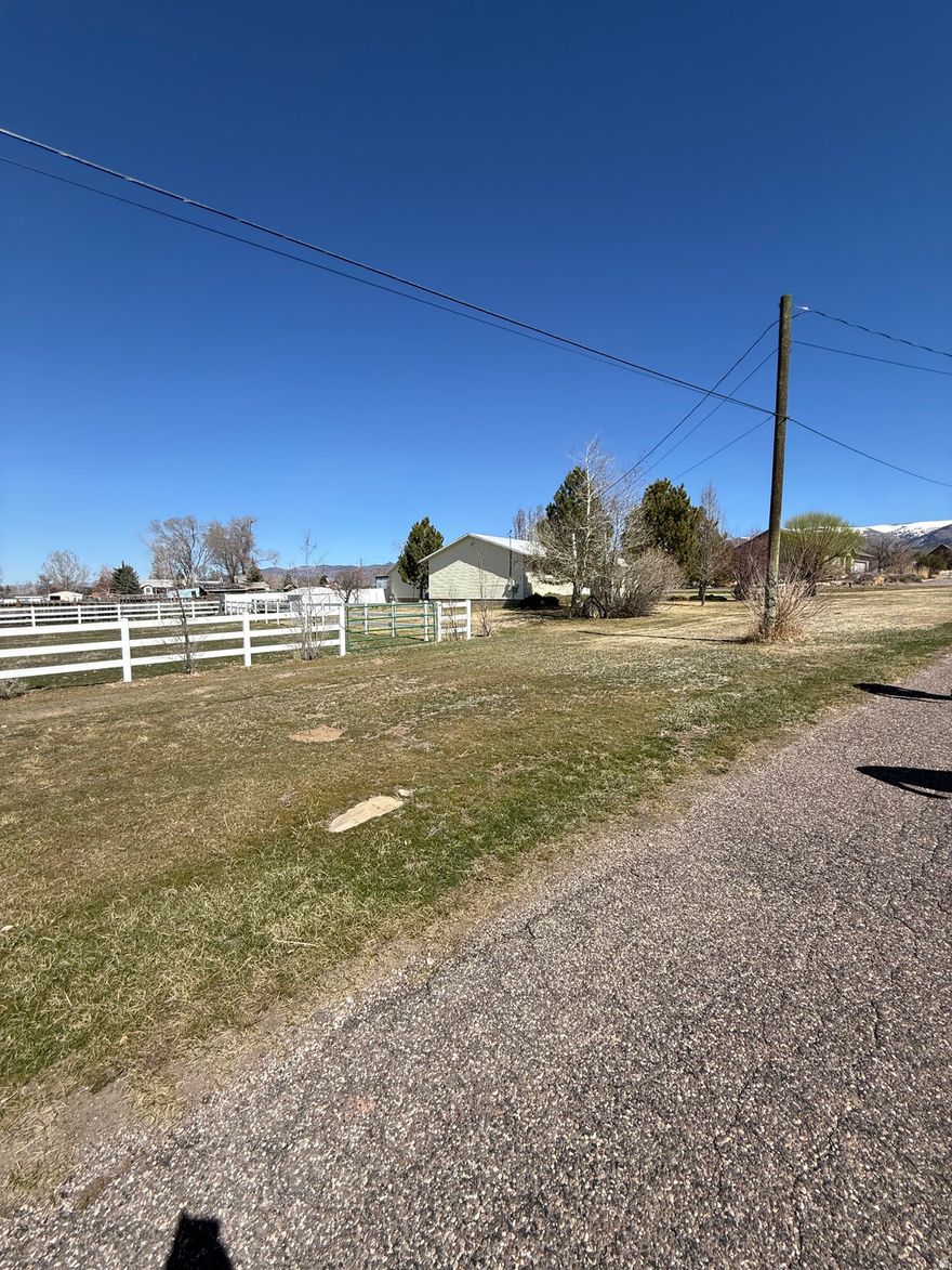 Charming home with fenced horse property and beautiful mountain views! Nestled just a few blocks from the elementary and high schools, this home offers a great blend of modern comfort and small-town charm. Located in a family-friendly neighborhood, this home is ideal for families, first-time buyers, or anyone looking for a peaceful yet convenient location. This home has a fresh, airy feel while maintaining its cozy character. The layout provides plenty of room for gatherings, and the yard offers a great space for kids to play or to host summer barbecues. Buyer to verify all pertinent information regarding this listing.