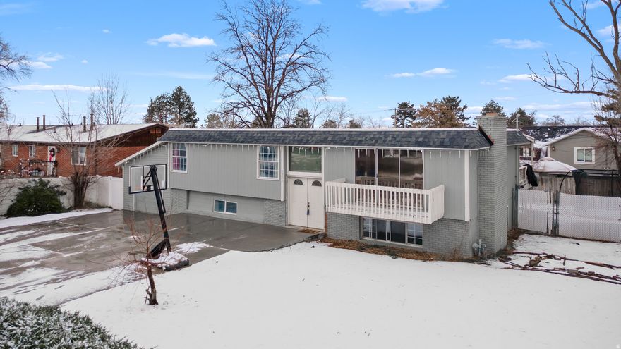 This bright and roomy home is nestled in a desirable East Sandy neighborhood, offering easy access to shopping, dining, parks, top-rated schools, flat iron park, falcon park, and just minutes from world-class ski resorts. Step inside to an inviting entry highlighted by sleek gray-toned flooring and a contemporary chandelier that sets the tone throughout. The open-concept kitchen and great room create a warm, welcoming space ideal for everyday living and entertaining. The beautifully updated kitchen features modern gray cabinetry, a stylish tile backsplash, a center island, stainless steel appliances, and elegant quartz countertops. Adjacent to the kitchen, the great room offers a cozy fireplace for relaxing evenings, along with sliding glass doors that lead to a balcony showcasing breathtaking mountain views. The main level includes a generous primary bedroom with an ensuite bathroom featuring a tiled shower. Two additional spacious bedrooms and a full bathroom complete this floor. Downstairs, the fully finished basement offers a large family or theater room, two oversized bedrooms, a full bathroom, and a convenient laundry area. From the kitchen, step out onto the covered deck to take in the mountain scenery, or head down to the expansive, fully fenced backyard-perfect for gatherings, play, or outdoor relaxation. Parking is plentiful with a one-car garage and an oversized driveway for additional vehicles. This move-in-ready home is packed with recent upgrades completed in 2021/2022, including a new furnace, air conditioner, water heater, electrical updates, main water line, sewer line and a brand-new roof. This is one you don't want to miss out on.  Square footage figures are provided as a courtesy estimate only and were obtained from county record. Buyer is advised to obtain an independent measurement.