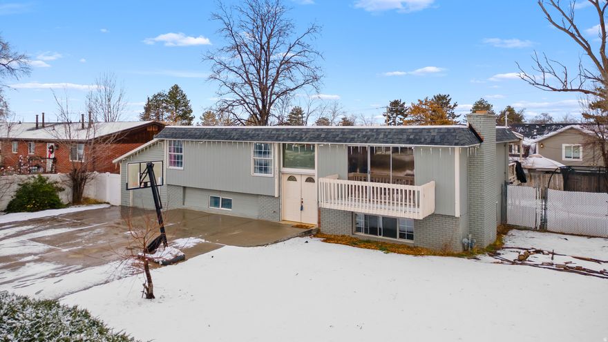 This bright and roomy home is nestled in a desirable East Sandy neighborhood, offering easy access to shopping, dining, parks, top-rated schools, flat iron park, falcon park, and just minutes from world-class ski resorts. Step inside to an inviting entry highlighted by sleek gray-toned flooring and a contemporary chandelier that sets the tone throughout. The open-concept kitchen and great room create a warm, welcoming space ideal for everyday living and entertaining. The beautifully updated kitchen features modern gray cabinetry, a stylish tile backsplash, a center island, stainless steel appliances, and elegant quartz countertops. Adjacent to the kitchen, the great room offers a cozy fireplace for relaxing evenings, along with sliding glass doors that lead to a balcony showcasing breathtaking mountain views. The main level includes a generous primary bedroom with an ensuite bathroom featuring a tiled shower. Two additional spacious bedrooms and a full bathroom complete this floor. Downstairs, the fully finished basement offers a large family or theater room, two oversized bedrooms, a full bathroom, and a convenient laundry area. From the kitchen, step out onto the covered deck to take in the mountain scenery, or head down to the expansive, fully fenced backyard-perfect for gatherings, play, or outdoor relaxation. Parking is plentiful with a one-car garage and an oversized driveway for additional vehicles. This move-in-ready home is packed with recent upgrades completed in 2021/2022, including a new furnace, air conditioner, water heater, electrical updates, main water line, sewer line and a brand-new roof. This is one you don't want to miss out on.  Square footage figures are provided as a courtesy estimate only and were obtained from county record. Buyer is advised to obtain an independent measurement.