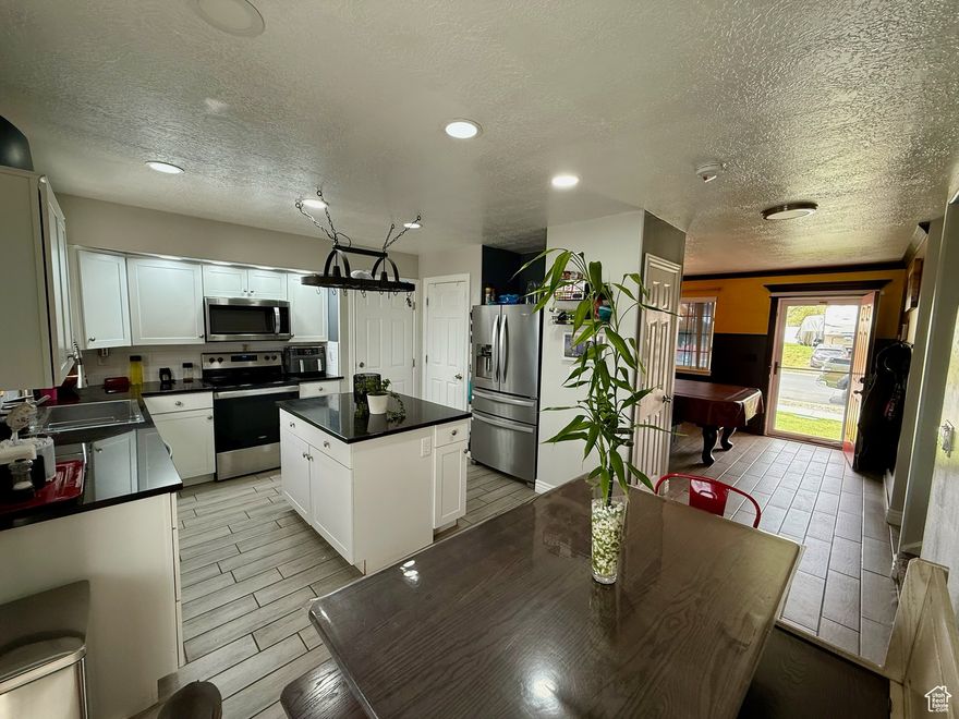 Sellers are motivated, make  an offer (needs 3rd party approval) Come see this gorgeous updated home in Saratoga Springs! To many upgrades to mention! Solar panels (paid off!) wet bar, brand new flooring, 7 bedrooms with a potential for 8, 3 full baths, finished storage room, 2 car garage, RV parking with new dedicated redesigned fence line and gate for easy access and parking of RV (2nd driveway!) Brand new roof (May 2024), fenced garden area, NO HOA, Shed on concrete, Office shelving and pool table included if buyer wants them!