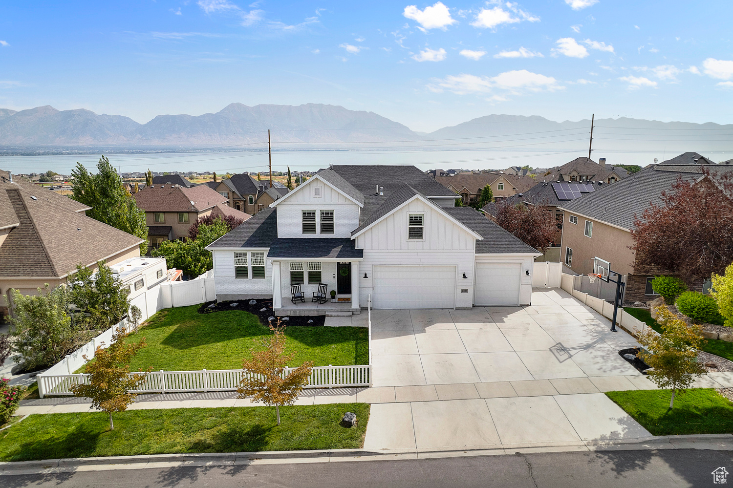 Built in late 2018, this beautifully maintained home offers modern design, high-end finishes, and incredible views of Utah Lake and Mount Timpanogos. Inside, upgrades include custom lighting, modern fireplaces on every level, a whole-home water softener, as well as a handful of smart-home capabilities. The open layout is bright and welcoming, with extra tall ceilings that let in an abundance of natural light. The primary suite offers a double-wide vanity, separate shower & tub, and an enviable walk-in closet The basement has been finished with over $100k in upgrades, offering a full kitchen with stainless steel appliances, a large 8'-long island, two bedrooms, one and a half baths, laundry, and abundant storage. Its 9-foot ceilings make you forget you're in a basement. This home provides excellent income potential while also being ideal for owner-occupancy. The oversized three-car garage features 13-foot ceilings, an extra-deep third bay, and wiring in two locations for EV charging. The backyard offers space for future features such as a firepit, hot tub, or shed, all within a safe, friendly neighborhood with no HOA. Lovingly cared for and designed as a forever home, this property is move-in ready with comfort, style, and flexibility in every detail!