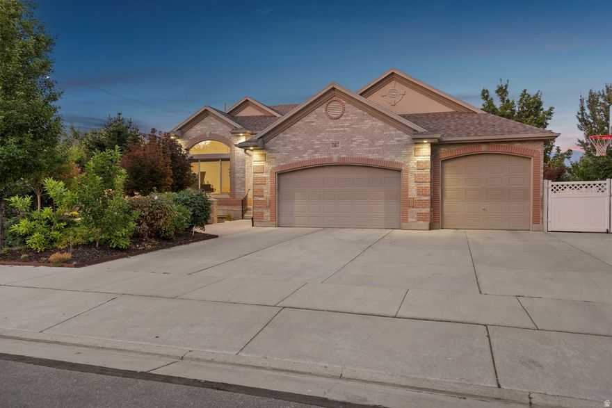 Welcome to this luxurious, recently renovated rambler in the highly sought-after Jordan Farms neighborhood of South Jordan with no HOA, featuring over $250,000 in designer upgrades completed in 2022 that seamlessly blend upscale finishes with everyday comfort. The chef's kitchen boasts a Sub-Zero refrigerator, high-end built-in range and stove, and a large island ideal for entertaining, while the dining area is accented by elegant built-in china cabinets. The primary suite offers a true retreat with a no-step steam shower, soaking tub, and illuminated walk-in closet, complemented by two additional main-floor bedrooms and a spacious laundry room for effortless single-level living. The home includes a 4-car garage and RV parking with access to a private basement entrance, offering potential for a mother-in-law apartment or rental complete with its own entrance, second kitchen, second laundry, two bedrooms, a bathroom, theater room, and custom office. Outside, enjoy breathtaking Wasatch Mountain views from the new concrete deck and relax in the professionally landscaped backyard with mature trees and an 8-foot privacy wall. Sq Ft provided as a courtesy, buyer to verify.