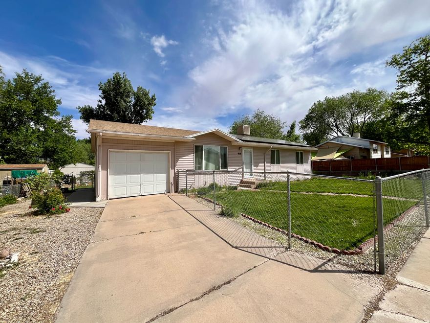 IN-TOWN GEM with an unbeatable location and spacious lot! This well-maintained property offers a rare combination of indoor comfort and exceptional outdoor living. Enjoy a large garden area, beautifully established and fully fenced yard, two storage sheds, and a private covered back patio, perfect for relaxing or entertaining. Inside, the home features a functional open layout with the kitchen flowing seamlessly into the living area, plus convenient access to the laundry space. Recent updates include new large windows, new roof, solar panels, and durable laminate flooring, providing both efficiency and style. Ample storage is found throughout. The primary bedroom includes space already designed for a future en-suite bath, offering added value and potential. This home is Ideal for those seeking outdoor space, gardening opportunities, or a centrally located place to call home. All information deemed reliable, but not guaranteed. Buyer to verify all.