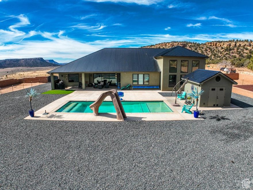 Experience the Apple Valley lifestyle in this beautiful home, nestled in a peaceful area with endless recreation. The modern kitchen boasts an induction cooktop, stainless steel appliances, an island countertop, and a large pantry with a sink, creating the perfect setup. The spacious living area features sliding glass doors leading to a covered patio, a sparkling pool with a slide, plus an outdoor shower and restroom in the pool house. The primary suite includes an exercise room, while a separate casita can serve as a short-term rental. The garage offers an RV area with water/sewer hookups, three 220V outlets for RV, EV, or welder, epoxy floors, and overhead storage. This home offers the perfect blend of comfort, convenience, and entertainment. It is prewired for a whole-house generator, ensuring peace of mind. Built with durable 2x6 construction, the main home offers superior insulation, while the casita includes sound-barrier insulation for added privacy. The property is enclosed by a sturdy block wall, providing seclusion, and creating a spacious area perfect for a garden or orchard. This home offers the perfect blend of comfort, convenience, and entertainment. Don't miss an opportunity to make it yours!