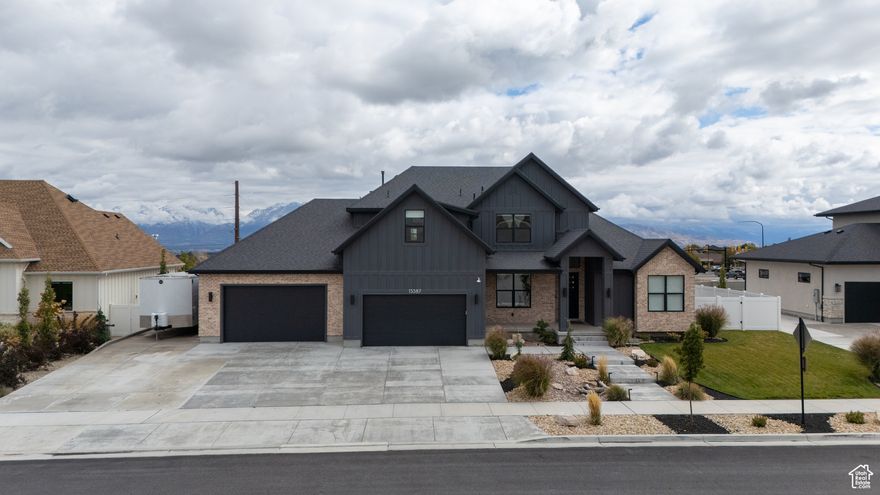 Experience refined living in this high-end two-story home located in beautiful Herriman, Utah. This exceptional residence showcases 4 spacious bedrooms, 3.5 designer bathrooms, and an oversized 6-car garage with epoxy floors and RV parking (13' by 45'). The home's professional landscaping is enhanced by outdoor lighting and a stunning exterior waterfall feature, creating an impressive and serene outdoor setting. Inside, you'll find real hardwood floors, tall ceilings, and quartz countertops that pair perfectly with sleek stainless steel appliances for a modern yet timeless feel. Every detail has been thoughtfully designed for both style and comfort. Conveniently situated near top-rated shopping, restaurants, and highway access, this home offers the perfect balance of luxury and location.