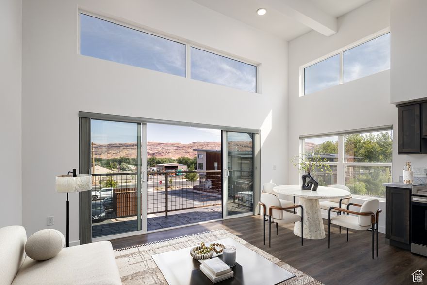 EXCEPTIONAL BALCONY LIVING with long-range views of the La Sal Mountains, Swiss Cheese Ridge, and Arches National Park. This upper-story 2-bedroom condominium flaunts 11-14 foot ceilings, generating an open and airy space with exceptional wall art opportunities.  Welcome to the Kane Creek Condominium community, located on the recreational pathway of the beautiful new and improved Kane Creek Boulevard, taking you to Colorado River beaches, quaint canyons, and world-class mountain biking trails such as Amasa Back. A short stroll to downtown Moab and minutes to all that Moab has to offer at the base of the Moab Rim. This condo offers easy, low-maintenance living with common area rooftop decks, green space, independent laundry, and a dedicated parking spot, as well as access to dispersed parking and bike racks. You CAN live and play in Utah's adventure capital!
