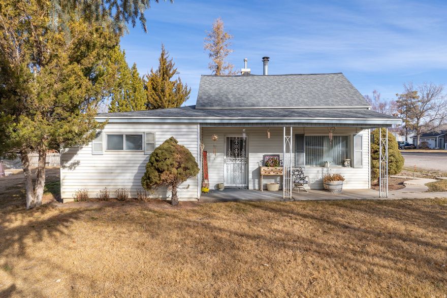 Charming 1935 cottage-style home offering comfortable single-level living on a spacious .53-acre lot. This well-laid-out home features a cozy wood-burning stove and a newer roof installed less than two years ago. The property offers excellent versatility with potential to subdivide for an additional home, sell off the west portion of the land, or enjoy the space for animals-bring your horse and experience the rare opportunity to enjoy country-style living within city limits. Additional highlights include pressurized irrigation, 200-amp power, a two-car covered carport, and a lovely neighborhood setting. A rare opportunity combining character, flexibility, and room to grow. All information within is provided as a courtesy only.  Buyer and Buyer's Brokerage are advised to complete their own due diligence.  Property boundary and lot lines are shown as approximate. Square footage figures are provided as a courtesy estimate only and were obtained from Tax Records and does not reflect the basement which includes storage and utility. Buyer is advised to obtain an independent measurement.