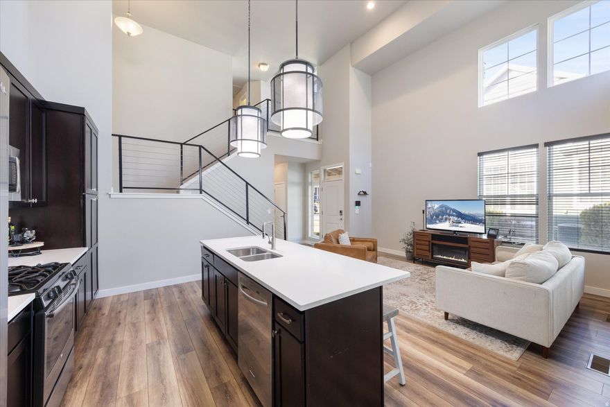 **No showings until the open house Sat Feb 4th** Welcome home to this well-kept North Shore Village townhome that truly lives like a single-family residence. Be sure to click the tour for a full video walkthrough of the space. Step into a welcoming great room highlighted by soaring two-story ceilings and expansive windows that flood the home with natural sunlight. The primary bedroom is conveniently located on the main level, while two additional bedrooms and a full bathroom are upstairs-perfect for guests, family, or a home office setup. The finished basement adds even more flexibility with a bonus room ideal for storage, a craft space, playroom, or hobby area. A security system and cameras are included for added peace of mind. Enjoy a prime location near Tulip Park, Harmons, and the North Shore of Oquirrh Lake, with easy access to Bangerter Highway and Mountain View Corridor. Residents also enjoy all that Daybreak has to offer, including swimming and splash pools, community gardens, sports courts, outdoor summer concerts, farmers markets, boating privileges on Oquirrh Lake, and so much more.*Buyer is advised to obtain an independent measurement. Buyer/Buyers Agent to verify all info including sq. ft.