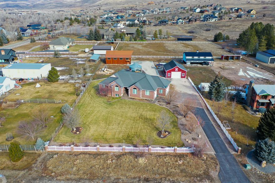 Set on 1.3 acres in the heart of Liberty, this property offers the rare combination of space, functionality, and true country living-while still being minutes from Ogden Valley recreation. With 3,344 square feet, 5 bedrooms, and 3.5 bathrooms, the home is designed for comfortable single-level living with additional space downstairs for guests, hobbies, or multi-generational use. The home features a walk-out basement with kitchenette, heated floors in the master bathroom, new hot water heaters, and a durable 40-year roof. A whole-house backup generator provides peace of mind, while the private well and septic system support independent rural living. Large windows and thoughtful layout make the home feel open, functional, and connected to the surrounding land. What truly sets this property apart are the improvements outside. Two substantial shops-a 30x40 red shop and a 36x48 wood shop with additional build-out space-create endless opportunities for work, storage, or recreation. A refurbished silo pavilion adds character and future potential for entertaining or creative use. With no HOA, plenty of room to spread out, and direct access to the lifestyle Ogden Valley is known for, this is Liberty living at its best.