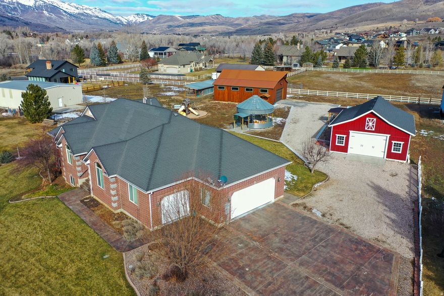 Set on 1.3 acres in the heart of Liberty, this property offers the rare combination of space, functionality, and true country living-while still being minutes from Ogden Valley recreation. With 3,344 square feet, 5 bedrooms, and 3.5 bathrooms, the home is designed for comfortable single-level living with additional space downstairs for guests, hobbies, or multi-generational use. The home features a walk-out basement with kitchenette, heated floors in the master bathroom, new hot water heaters, and a durable 40-year roof. A whole-house backup generator provides peace of mind, while the private well and septic system support independent rural living. Large windows and thoughtful layout make the home feel open, functional, and connected to the surrounding land. What truly sets this property apart are the improvements outside. Two substantial shops-a 30x40 red shop and a 36x48 wood shop with additional build-out space-create endless opportunities for work, storage, or recreation. A refurbished silo pavilion adds character and future potential for entertaining or creative use. With no HOA, plenty of room to spread out, and direct access to the lifestyle Ogden Valley is known for, this is Liberty living at its best.