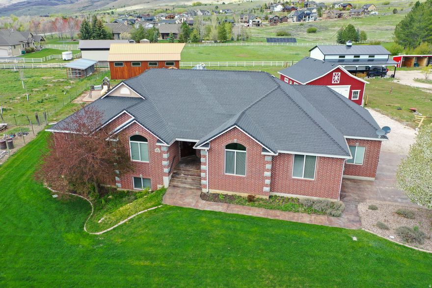 PRICE IMPROVEMENT! Set on 1.3 acres in the heart of Liberty, this property offers the rare combination of space, functionality, and true country living-while still being minutes from Ogden Valley recreation. With 3,344 square feet, 5 bedrooms, and 3.5 bathrooms, the home is designed for comfortable single-level living with additional space downstairs for guests, hobbies, or multi-generational use. The home features a walk-out basement with kitchenette, heated floors in the master bathroom, new hot water heaters, and a durable 40-year roof. A whole-house backup generator provides peace of mind, while the private well and septic system support independent rural living. Large windows and thoughtful layout make the home feel open, functional, and connected to the surrounding land. What truly sets this property apart are the improvements outside. Two substantial shops-a 30x40 red shop and a 36x48 wood shop with additional build-out space-create endless opportunities for work, storage, or recreation. A refurbished silo pavilion adds character and future potential for entertaining or creative use. With no HOA, plenty of room to spread out, and direct access to the lifestyle Ogden Valley is known for, this is Liberty living at its best.