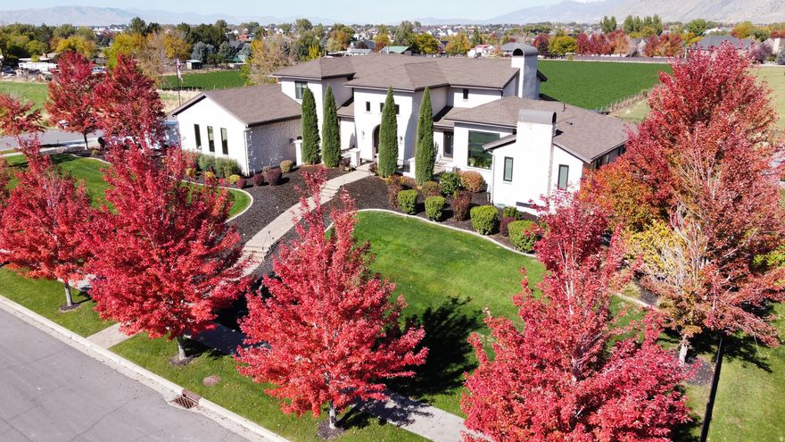 Offered at $5,000,000 and recently appraised at $5,500,000 this estate is priced to sell. This extraordinary Tuscany-inspired estate is perfectly situated in the heart of Mapleton on a rare, fully usable 1.54-acre flat lot, showcasing breathtaking, unobstructed mountain views. Spanning an impressive 12,276 square feet, the home features 6 bedrooms, 6 full bathrooms, and 2 half baths, thoughtfully designed with an incredible layout that balances grand-scale living with everyday comfort. The grounds are fully fenced and beautifully landscaped with mature vegetation, creating a private, resort-style setting highlighted by a stunning gunite heated pool with a diving board and expansive outdoor entertaining spaces including covered patios and hot tub. Just off the pool patio, a basement theater and large gaming area create the perfect space for hosting large gatherings.  The backyard is truly one of a kind, featuring a remarkable atrium-style greenhouse and a fully established vegetable garden that leads to a secluded secret garden stone cottage retreat, complete with a charming structure ideal for art, reading, yoga, or quiet reflection. Additional outdoor amenities include an oversized, top-of-the-line "Max-Air" in-ground trampoline, a life-size chess set for entertaining, and a well-appointed chicken coop, offering a unique blend of luxury and sustainable living.  Inside, the home continues to impress with a indoor basketball and pickleball court, complemented by a spacious workout room that overlooks the pool and surrounding mountain views, creating an inspiring space for recreation and wellness. The property also includes a spacious 7-car garage with two EV charging stations, a newly constructed detached ADU offering 2 bedrooms, 1 bathroom, 982 square feet, and its own private 3-car garage, as well as an additional mother-in-law apartment attached to the main residence.  Designed with both efficiency and security in mind, the home features a new roof, fiber internet, a fully paid-off solar system, a Generac backup generator, and a robust 24 lithium battery storage system. A secure safe room with a Fort Knox door provides added peace of mind, while full home automation, a premium SONOS sound system, and integrated camera systems deliver modern convenience. This is a rare opportunity to own a true legacy estate in one of Utah County's most desirable locations, where luxury, privacy, and lifestyle converge.  Adjacent half acre neighborhood retention lot acts as bonus yard with an orchard, sidewalk for scooters, grass field, and garden beds.  Square footage figures are provided as a courtesy estimate only and were obtained from building plans & appraisal.  Buyer is advised to obtain an independent measurement.