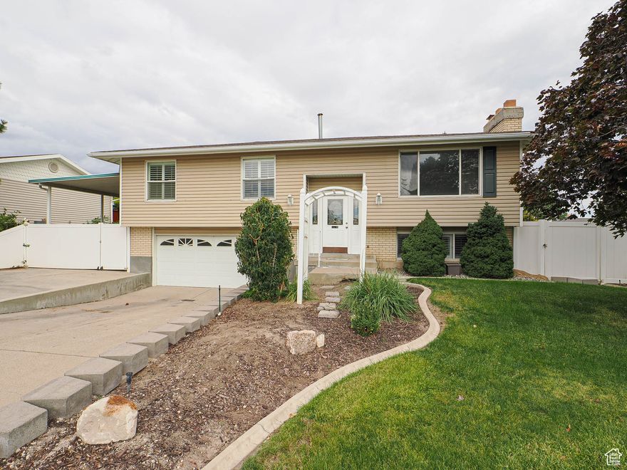 Wonderful indoor and outdoor living. This home has been loved for almost 2 decades. Updated kitchen, new tile in baths and new carpeting throughout. New paint, some new lighting with new vanity downstairs.  Large deck off kitchen 12' x 23.5 ' (with a cover) for entertaining year round; it can be like an outside family room its so big, concrete flat work has been done recently in excellent condition. Fully fenced back yard with large and tall covered carport awning 12 feet', a long driveway on the side for RV parking (from gate to rear fence 61').  In back, there is enough parking for 2 RV'S! Come see all the options.  The basement area can be used for a large bedroom or family room space. Enjoy. Easy to show.