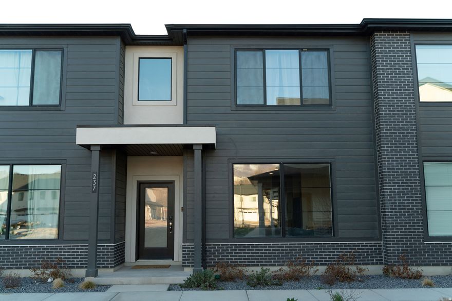 Nearly new townhome in one of Spanish Fork's most desirable communities with incredible amenities and unbeatable location. Built just months ago and lightly lived in, this home offers the rare opportunity to skip the wait and hassle of new construction while enjoying thoughtful upgrades. Unlike the base builder models, this home includes an oversized kitchen island, custom added pantry storage under the stairs for extra organization and functionality, upgraded window drapes, and several additional finishing touches that make the space feel complete and move-in ready. Everything is already done for you so you can move in immediately without the extra expense and time typically required with a brand-new build. The layout is open, bright, and welcoming, with modern finishes, comfortable living spaces, and beautiful natural light. Step outside and enjoy gorgeous panoramic mountain views and one of the best locations in Spanish Fork. Just off Main Street and directly next to the well-known Spanish Fork Fairgrounds. This community is packed with amenities that are difficult to find elsewhere, including:  Heated swimming pool  Two playgrounds  Pickleball courts  Dog parks  Large grassy common areas  Hammock hanging area  Pavilions and grills for gatherings  Ample guest parking throughout the neighborhood Whether you're relaxing by the pool, enjoying the open green space, or taking advantage of the recreation areas, the neighborhood is designed for both convenience and lifestyle. With brand-new homes still being built in the area, this home stands out as a fully finished, upgraded, and move-in ready option available today. Come see why this nearly new home is one of the best values in Spanish Fork.