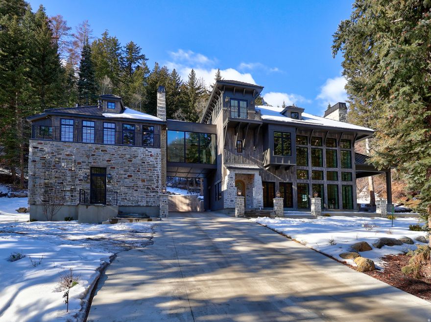 This is a rare opportunity to own Pont de Reve: one of the country's finest mountain-modern estates, and the crown jewel of Sundance.  Beginning at the exquisite architectural bridge, you'll cross over the North Fork Provo River into this exceptionally private cul-de-sac, where this healing enclave rests in the lea of Mount Timpanogos.   Experiencing this inspiring space is a must for architectural enthusiasts, with floor-to-ceiling natural light, elegant minimalism, and perfectly appointed rooms.  Just underneath Sundance Mountain Resort's Nordic Center trails, this home features riverside outdoor entertaining spaces, European lime-washed stonework, Wolf/Sub-zero/Scotsman appliances, heavy-timbered Japandi design, heated floors and driveways, lime-washed painted interiors, workout room with mountain views, french oak floors, soundboards throughout bedrooms, dual toilet rooms in principal bath, bunk room, "bridge" theater room, pass-through driveway with private parking, outdoor fireplace, and 1200 square feet of tall crawl space for storage.  There is also an unfinished, flex-space ADU with a separate entrance, for either a studio dwelling or additional game room.  Come experience this mountain masterpiece, inspired by architect Jeffrey Dungan!   *Square footage figures are provided as a courtesy estimate only and were obtained from the architectural plans.  Buyer is advised to obtain an independent measurement.