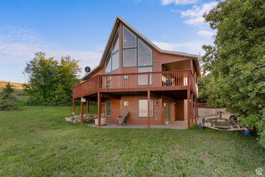This fractionally shared, well-maintained cabin offers the perfect Bear Lake retreat with 5 bedrooms and 3.5 bathrooms. The vaulted great room features expansive view windows and a striking rock fireplace, creating a warm and inviting gathering space. The kitchen and dining area flow seamlessly into the great room, ideal for entertaining. Step outside to a spacious deck and covered patio with stunning views of Bear Lake, surrounded by mature trees and a well-kept lawn that enhance the cabin's sense of privacy. The lower level includes a second living room and game area, also with a rock fireplace, providing additional space to relax. Sleeping 13 in beds, this cabin is perfect for larger groups or family getaways. Enjoy year-round access and a prime location just minutes from Bear Lake State Park Marina, downtown Garden City shops and restaurants, and only 20 minutes from Beaver Mountain Ski Resort. Price is for 1/4 share. No nightly rentals allowed.