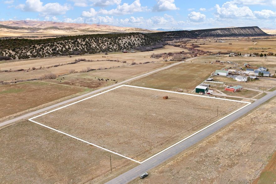 Beautiful 5.04-acre building lot in Milburn, Utah featuring stunning mountain and valley views. Includes drilled well with underground water and 14 shares of Gooseberry irrigation water. Frontage on two roads offers great access. Prime rural property with space to build your dream home.  Coordinates;  39.64555 N, 111.43671 W