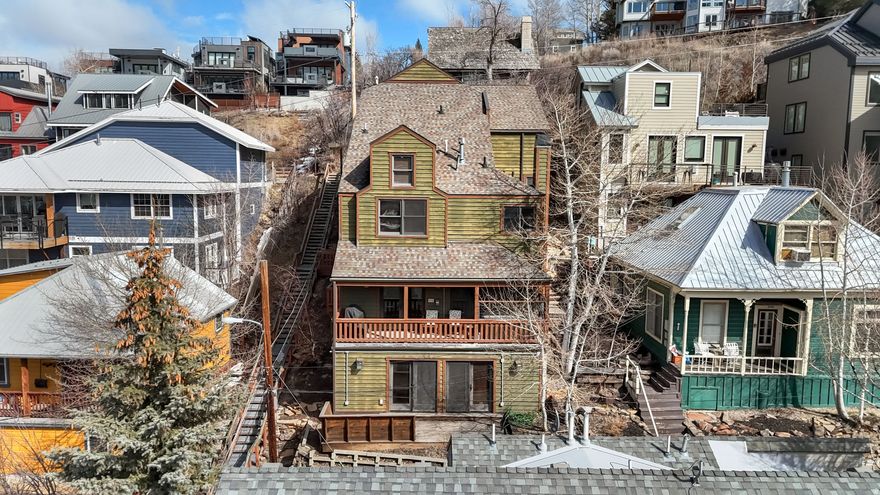 Located in the heart of Park City's coveted Old Town neighborhood, this meticulously maintained residence blends timeless mountain architecture with exceptional modern comfort. Perfectly positioned just steps from the iconic Shorty Stairs, the home offers direct walkable access to Main Street's renowned restaurants, galleries, and shopping while capturing beautiful views of Old Town and Park City Mountain Resort. Spanning more than 3,700 square feet across multiple levels and serviced by a private elevator, the home was thoughtfully built on more than one traditional Old Town lot, allowing for larger living spaces, generous bedrooms, and an ideal layout for both entertaining and everyday living. The main living area is designed for gathering, featuring a spacious great room with a gas fireplace that flows seamlessly into a chef's kitchen equipped with premium Viking gas appliances, granite countertops, and a distinctive copper island and backsplash. The kitchen opens to both formal and casual dining spaces, creating an inviting environment for hosting family and guests. Five well-appointed bedrooms, three with ensuite bathrooms, provide comfort and privacy, while additional den and media rooms offer flexible spaces for work, relaxation, or movie nights after a day on the slopes. Outdoor living is equally impressive with two balconies and multiple entrances to the home, allowing easy access throughout the property. Enjoy the private hot tub after skiing or take in the stunning views overlooking Old Town and Park City Mountain. Designed with both luxury and practicality in mind, the home features high-end finishes throughout, solid soundproof construction, integrated audio speakers, CAT6 wiring, reverse osmosis filtration, a new water softener system, an emergency water shutoff valve, and a brand-new furnace with a humidifier. Additional highlights include a two-car garage and a heated two-car driveway, providing rare convenience in Old Town. With its exceptional construction, spacious design, and unbeatable location just minutes from the slopes and steps from Main Street, this home offers a rare opportunity to experience the very best of Park City living.