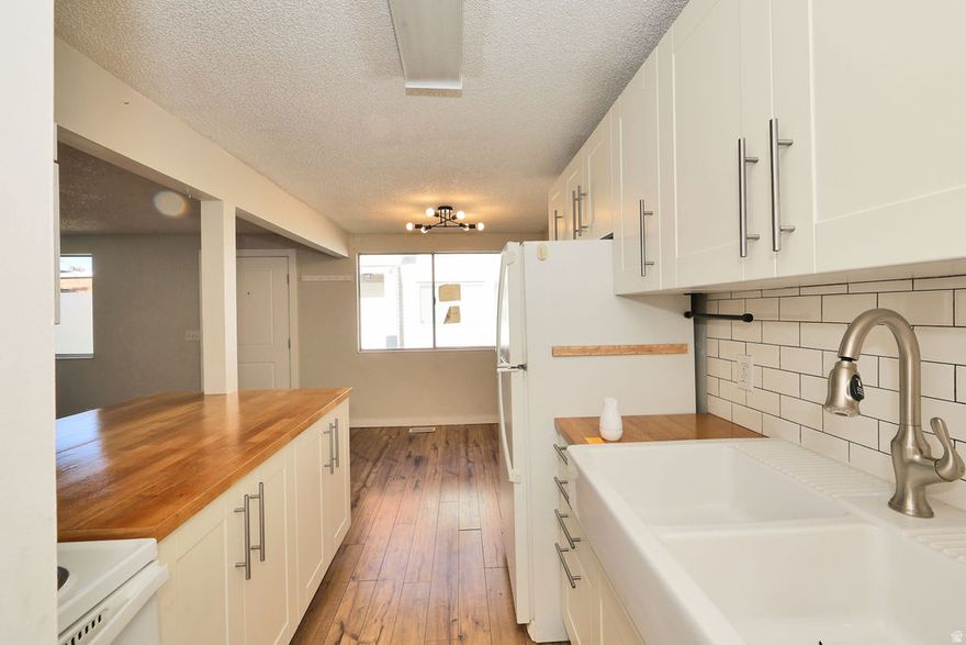 This Meadowbrook Condo is ready for its next owner. Kitchen has white shaker cabinets, butcher block countertop, and farm-house sink. Living area with laminate flooring, large windows, and brick accent wall. Main bedroom with ceiling fan & walk-in closet. Upstairs bathroom updated with ship lap style walls, vanity with porcelain sink, and bronze bathroom hardware.