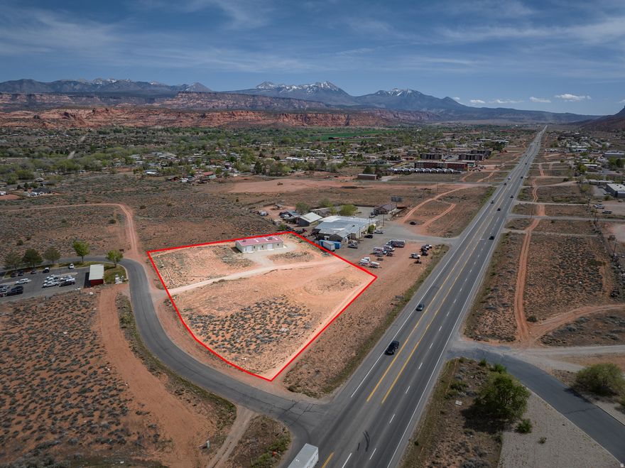COMMERCIAL DEVELOPMENT OPPORTUNITY. Prime 2.34-acre corner lot with Highway Commercial zoning at the intersection of Resource Blvd and Hwy 191. High-visibility location with strong traffic exposure and excellent access, conveniently positioned south of town. The property includes a 3,035 SF building (75.3' x 40.3') built in 2007. Utilities are available, including municipal water and sewer. Expansive red rock and valley views add to the appeal. Suitable for a variety of mixed uses- high density residential and commercial.