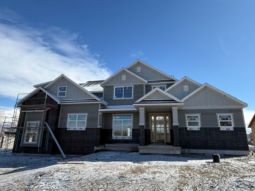Rarely do you find a brand-new estate on a half-acre in the heart of Lehi. Currently at the sheetrock stage, this 2-story residence by Sweetwater Homes offers a unique opportunity to secure a high-end property before the spring rush. This isn't a "cookie-cutter" build; it is a custom-caliber home designed for those who value space, privacy, and intentional design.  House selections by Alika Design. Forget the stress of picking finishes. The entire interior and exterior has been curated by the Alika Design team. Expect a cohesive, modern aesthetic where every quartz surface, custom light fixture, and tile choice works in harmony to create a sophisticated yet "homey" environment.  The Culinary Hub The kitchen is the center of gravity in this home.  Scale & Service: A massive gathering island is complemented by a professional-grade, double-wide fridge/freezer and premium quartz tops.  The "Hidden" Factor: A true walk-in hidden pantry keeps the main kitchen spotless while providing a second space for storage.  Precision: Custom soft-and-slow close cabinetry throughout-a hallmark of Sweetwater quality.  Main Floor Luxury & Living  The Master Wing: Secluded on the main floor, the master suite is a true retreat. It features a spa-inspired bath with a freestanding soaking tub, a large walk-in shower, and the rare luxury of his-and-hers walk-in closets.  Upper Level Loft: Upstairs, the floor plan opens into a sprawling loft-the perfect buffer between the bedrooms and an ideal space for a secondary family room.  The Garage: A 3-car attached garage ensures plenty of room for vehicles, gear, and storage.  The Grounds The half-acre lot is a blank canvas. Whether you envision a detached shop, a swimming pool, or a private backyard oasis, the 0.46 acre footprint provides the rare freedom to build it.  Specs at a Glance:  Bed/Bath: 4 Bedrooms | 2.5 Bathrooms  Dimensions: 3,090 Finished SQFT | 5,169 Total SQFT  Basement: 2,079 SQFT (Unfinished - ready for your future theater or gym)  Status: Sheetrock Stage (Estimated completion: April 2026)