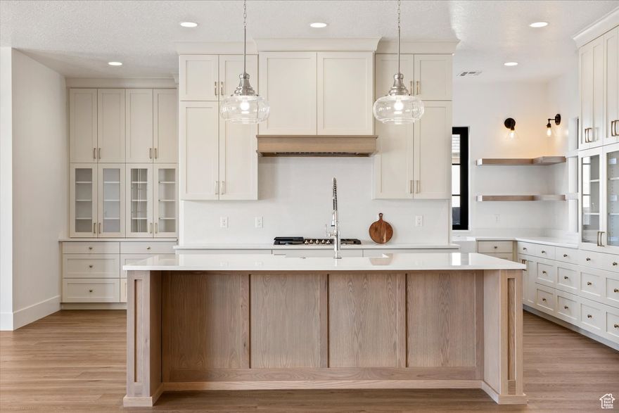 Amazing, nearly new custom home with striking curb appeal and a welcoming wrap-around porch, perfect for relaxing evenings. Inside, a spacious main floor primary suite and 12' slider create an open and airy feel. Soaring ceilings and thoughtful finishes include quartz countertops, upgraded fixtures, shiplap, board and batten, floating shelves, and custom cabinetry throughout. The gourmet kitchen is a showstopper with GE Caf appliances, double ovens, a large island, and a wrap-around butler's pantry. Built with quality 2x6 framing and gas plumbed to patio. The fully insulated garage and RV parking add convenience, while the location near recreation areas and schools makes this home as practical as it is beautiful. Agent is related to seller.