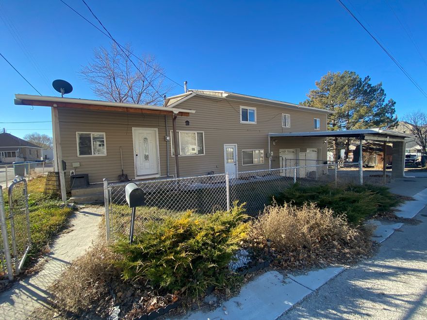 Square footage figures are provided as a courtesy estimate only and were obtained from court house records.  Buyer is advised to obtain an independent measurement.  Property being sold AS IS with no warranties.  This two-story home offers great potential with some minor upgrades and a little TLC.  Featuring 4 bedrooms, 2 full bathrooms, and a quarter bath, the layout provides ample space for comfortable living.  Situated on a large corner lot in the heart of Helper.  You will love the extra-large garage along with a double carport.  The side yard has 2 storage sheds, a beautiful rock fireplace and plenty of extra space for entertaining.   Basement are is for furnace,  water heater and storage only.  This is a great opportunity for buyers looking for a great investment.  Call today for your showing this home is priced to sell quickly.