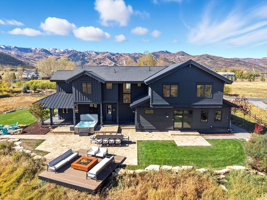 Set on a quiet cul-de-sac in the heart of Park City's coveted Old Ranch Road neighborhood, this modern alpine retreat is one of the only fully modernized estates on more than two acres within the Park City School District. Surrounded by acres of open space and wetlands, the property delivers rare privacy and forever views that sweep from wildlife-filled meadows to the Wasatch Range and across to the Canyons at Park City Mountain Resort.  Reimagined in 2024, every space was tailored for today's mountain lifestyle. The foyer opens to expansive living areas where walls of glass dissolve into the landscape. At the center, a chef's kitchen with Wolf appliances and a discreet induction island anchors the dining and great room, flowing seamlessly to a patio designed for year-round entertaining, from aprs-ski evenings by the fire to starlit summer gatherings.  Upstairs, a great room with an elongated fireplace and custom kitchenette creates a retreat for family and guests, complemented by three uniquely styled bedrooms. A private wing holds the primary suite with panoramic mountain vistas, a spa bath with soaking tub and advanced steam shower, and a boutique-style closet with natural light and a center island.  Designer lighting, curated finishes, and statement textures elevate the home throughout. Preliminary plans envision nearly doubling the square footage with a vaulted great room and additional walls of glass that frame both wetlands and ski slope vistas.  This estate is more than a residence. It is a rare vision of Park City living, peaceful, private, and sophisticated, just a stone's throw from the Canyons, five minutes to Main Street, and five minutes to Kimball Junction.