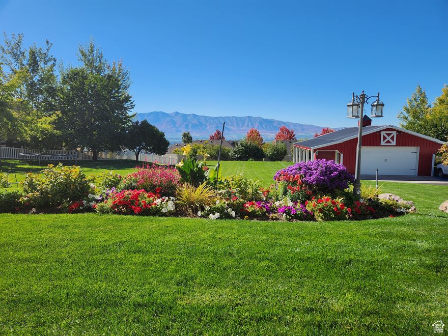 STUNNING PANORAMIC VIEWS & A DREAM BARN!  An extraordinary custom home nestled on Providence's coveted east bench where scenic serenity meets upscale living.  Perched on over half an acre, this one-of-a-kind property offers gorgeous views of Cache Valley and the Wellsville Mountains that will leave you breathless every single day! What truly sets this property apart? The iconic 24x35' RED BARN--a standout feature rarely available.  Whether you're looking for a workshop, storage for recreational toys, a creative studio, or to explore the potential of an accessory dwelling (ADU), this barn offers versatility and character.  Inside you'll find 4 bdms, 5 baths, over 4200 sq ft of thoughtfully designed living space across 3 levels.  Two kitchens are ideal for multigenerational living or entertaining. The spacious layout includes main-level living, a dedicated exercise room, two fireplaces, an office/bedroom and three generous family rooms-each designed with comfort & connection in mind. Step outside to a beautifully landscaped yard featuring fruit trees, garden boxes, flower beds and expansive outdoor living areas, including a deck and lower-level patio--perfect for soaking in those show stopping sunsets.  This property also enjoys a quiet location within a highly desirable neighborhood.  Recent updates and a price improvement make this a rare opportunity to own a true gem in Cache Valley.