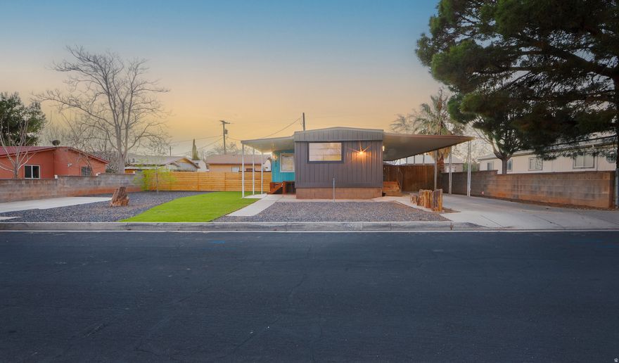 Stunningly cute home with a two-car garage, loads of off-street and RV parking, and no HOA. This unique property has been meticulously renovated from top to bottom, inside and out. Flooring, windows, siding, fixtures, appliances, insulation, HVAC, and landscaping have all been professionally updated to create a charming "tiny-home" vibe with abundant natural light throughout. There is also an additional small room that could work well as a 3rd bedroom or office. The fully xeriscaped yard and beautiful lawn offer minimal maintenance, with two fully fenced areas for kids and pets and a brand new shed with a cement foundation for extra storage. The nearly quarter-acre property features eight off-street parking spaces (three covered) for RVs, toys, and guests, plus a two-car garage. Located within walking distance to stores, Snow Canyon State Park, city parks, schools, pickleball courts, and more. A separate tiny home is located at the back of the property and is currently occupied; it is not included in the sale but may be negotiated separately. Please do not disturb the occupant.