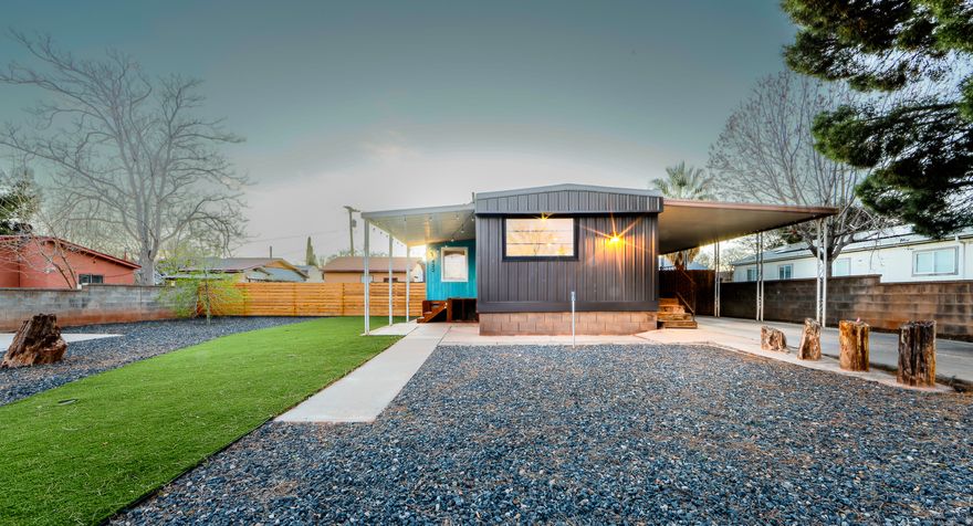 Stunningly cute home with a two-car garage, loads of off-street and RV parking, and no HOA. This unique property has been meticulously renovated from top to bottom, inside and out. Flooring, windows, siding, fixtures, appliances, insulation, HVAC, and landscaping have all been professionally updated to create a charming "tiny-home" vibe with abundant natural light throughout. There is also an additional small room that could work well as a 3rd bedroom or office. The fully xeriscaped yard and beautiful lawn offer minimal maintenance, with two fully fenced areas for kids and pets and a brand new shed with a cement foundation for extra storage. The nearly quarter-acre property features eight off-street parking spaces (three covered) for RVs, toys, and guests, plus a two-car garage. Located within walking distance to stores, Snow Canyon State Park, city parks, schools, pickleball courts, and more. A separate tiny home is located at the back of the property and is currently occupied; it is not included in the sale but may be negotiated separately. Please do not disturb the occupant.